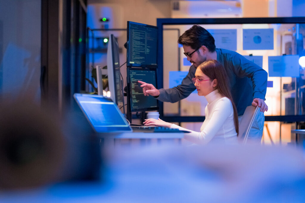 Technology and software sector, developers working across multiple monitors