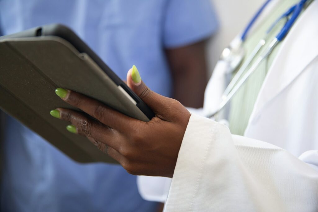 Clinician holding a tablet, healthcare AI advisory case study